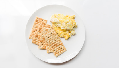A dish with salt cookies and beaten eggs.