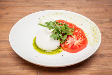 Buratta dish on a wooden background