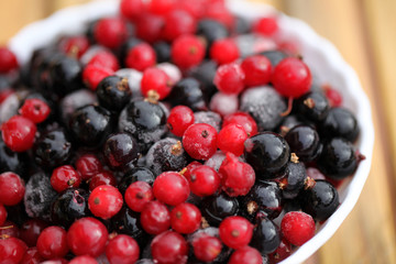 Frozen mixed berries as background. Currant mulberry texture pattern. Diet vegetarian food in winter.