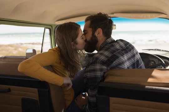 Couple kissing in vehicle on roadtrip