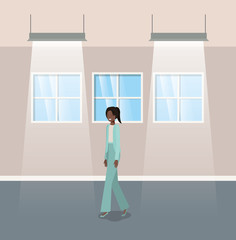 corridor with black businesswoman walking