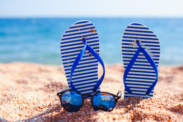 blue slippers and glasses on the beach