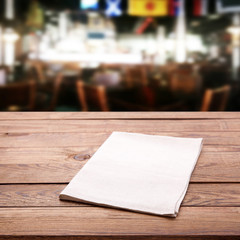 Tablecloth on wooden table and cafe blurred background