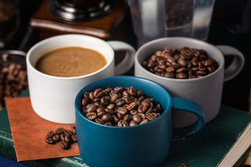Coffee cup and beans on old kitchen table.