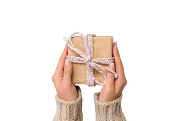 Woman hands give wrapped valentine or other holiday handmade present in paper with pink ribbon. Present box, decoration of gift Isolated on white