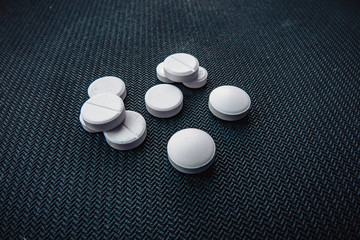 pills on black background