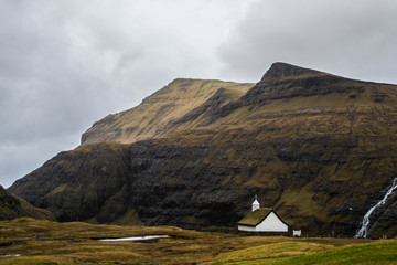 Beautiful landscape view of traditional historic lutheran Church with grass roof in Saksun village, Streymoy Island.Tourist popular attraction/place while sightseeing/exploring Faroe Islands (Denmark)