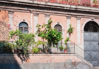 Fototapeta na wymiar Travel to Italy - facade of historical building in Catania, Sicily, ancient street