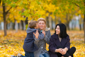 Young boy hugging and kissing his mother