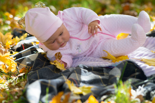 Baby Girl Falling Over As She Catches Leaves