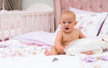 Baby is playing with toy in bed
