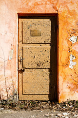Old orange wall with a door
