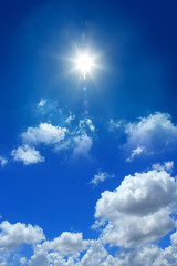 Naklejka na ściany i meble conceptual background image of blue sky with clouds and shining sun