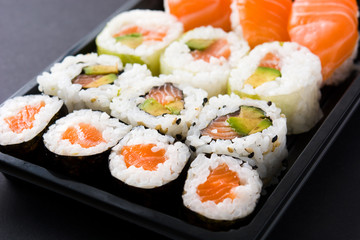 sushi pack with nigiri and maki on black background. Close up