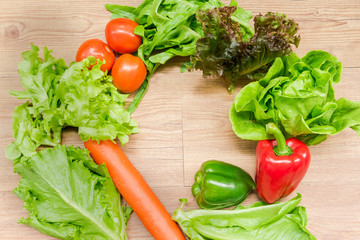 Obraz na płótnie Canvas Spring Vegetable Salads on a wooden table with copy space