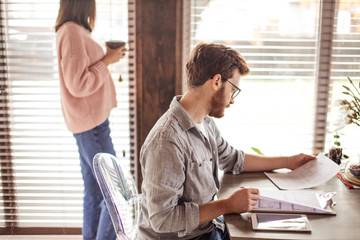 Male renter examines agreement renting new house, before buying real estate, close up view