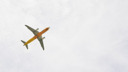 The plane flies in the sky in cloudy weather.