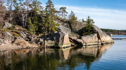 Fototapeta na wymiar rocky coastline in Finland with few pine trees
