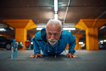 Portrait of senior man doing push ups