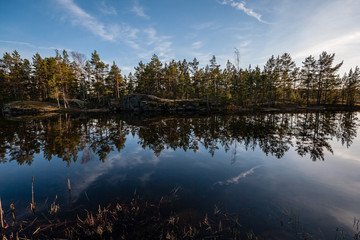colorful sunset on the lake with water reflections and dramatic storm clouds above