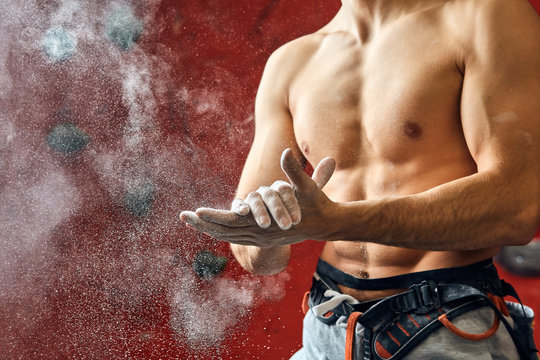 Unrecognizable Mid-section Portrait Of A Muscular Climber Man Coating His Hands In Powder Chalk Magnesium And Preparing To Climb Indoor, Close-up