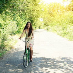 Happy young beautiful woman with retro bicycle. Portrait of fresh girl with cycle over summer outdoor, image toned.