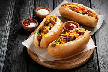 Homemade Hot Chili Dog with Cheddar Cheese and grilled vegetables