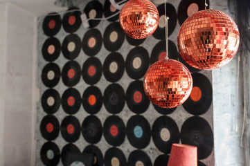 A wall full of ordered vinyl records with diffrent colors in the middle near a window decoreted...