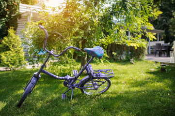 Fototapeta na wymiar Closeup photo of a medium sized vintage bike as a decor object in the garden of an wedding restaurant