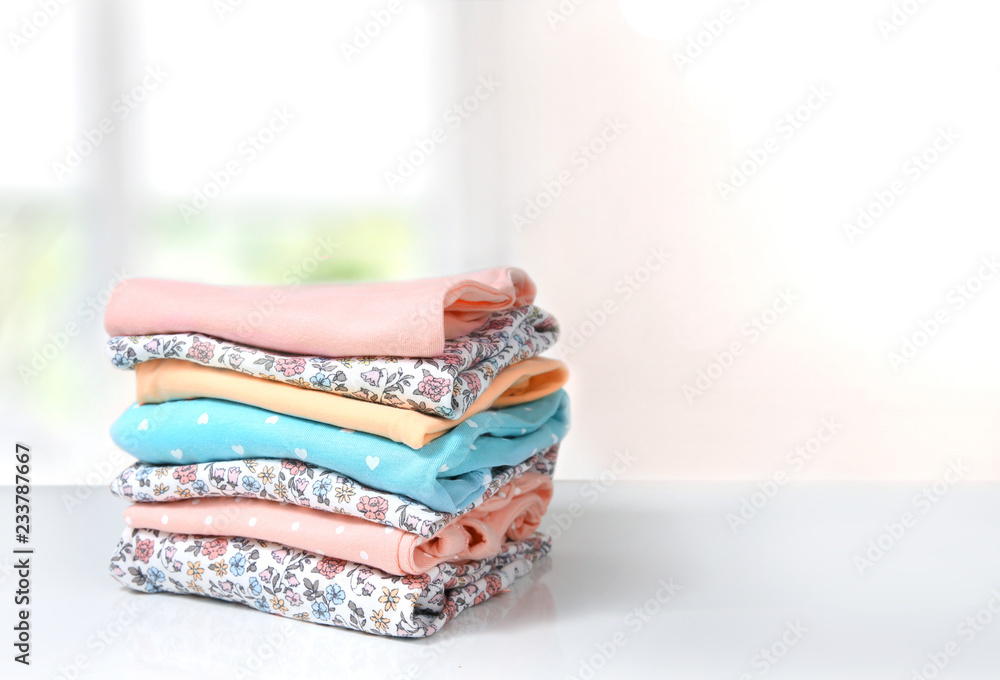 Wall mural Folded cotton clothes stack on table empty background. - Wall murals