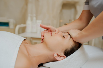 Obraz na płótnie Canvas Top view of Woman having curative facial massage. 