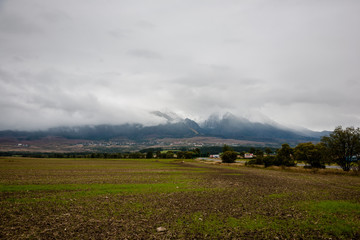 cloudy and misty Slovakian Western Carpathian Tatra Mountain skyline covered with forests and trees