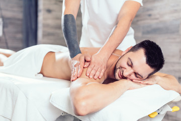Fototapeta na wymiar talented masseur massaging a man's sore back. treatment. reabilitation program