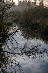 colorful sunset on the lake with water reflections and dramatic storm clouds above