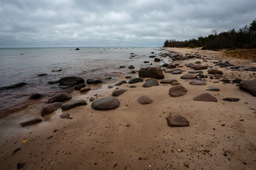rocky coastline in Latvia with flow water in the sea and large rocks
