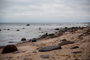 rocky coastline in Latvia with flow water in the sea and large rocks