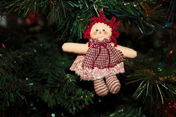 Handmade Raggedy Ann Doll Ornament hanging on a Christmas Tree