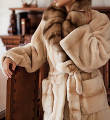 Girl in white fur coat from natural fur