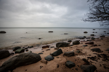 rocky coastline in Latvia with flow water in the sea and large rocks