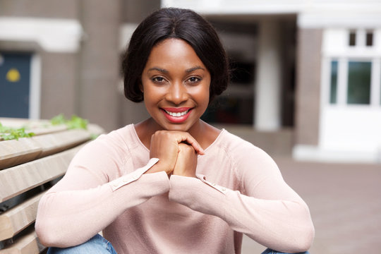 Close up smiling young african american woman outside