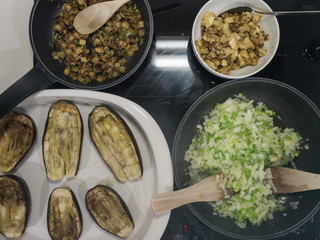 casseroles filled with vegetables on fire