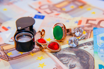 cash and jewelry with precious stones isolated on background