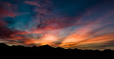 Tuinposter Aerial, drone view of sunset above Tubac, Arizona with mountin silhouettes and beautiful colors  © joel