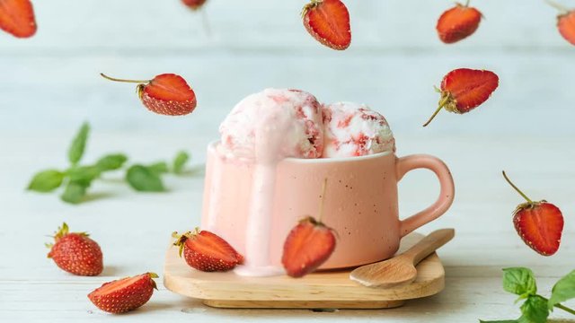 Cinemagraph - Strawberry ice cream in cup on wooden table. Drops of ice cream dripping . Motion Photo.