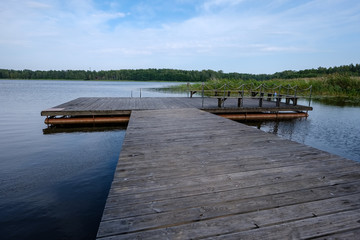 Obraz premium wooden and composite material foot bridge over water