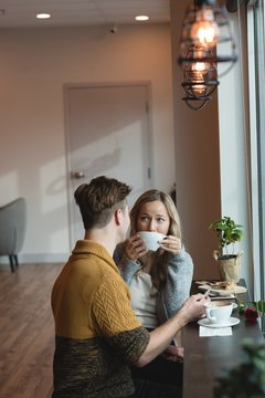 Couple interacting while having coffee