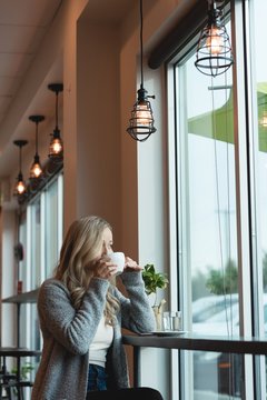 Woman having coffee in cafe
