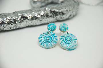 Small light blue winter stud earrings of polymer clay with christmas decor. Handmade jewelry isolated.