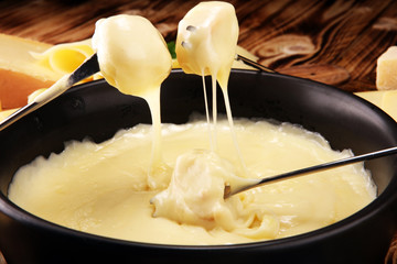 Gourmet Swiss fondue dinner on a winter evening with assorted cheese