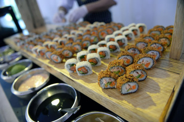 Kinds of sushi on a wooden board.